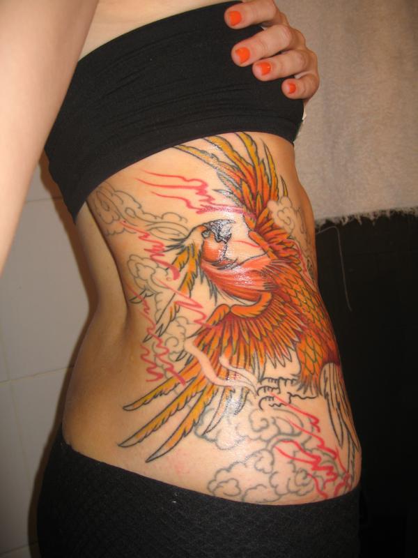 Colorful Phoenix Tattoo On Girl Right Side Rib