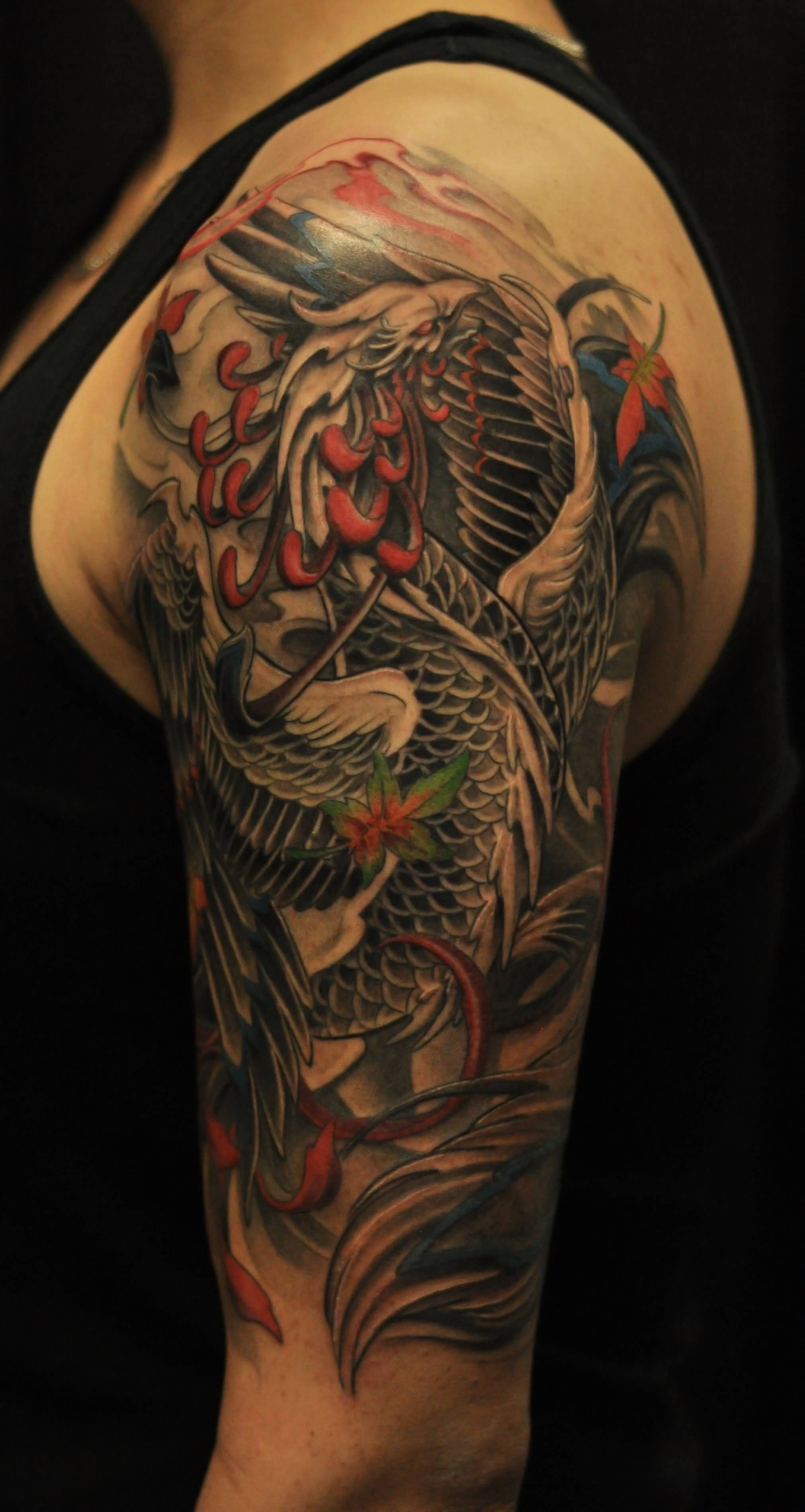 Colorful Phoenix Tattoo On Man Left Half Sleeve