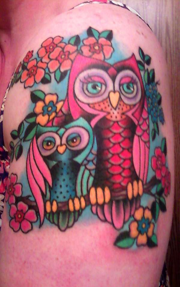 Colorful Traditional Two Owl On Branch With Flowers Tattoo On Left Shoulder