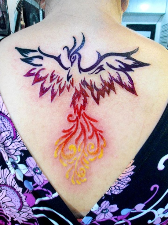 Colorful Tribal Phoenix Tattoo On Girl Upper Back