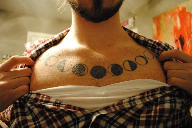 Cool Black Phases Of The Moon Tattoo On Man Collarbone.