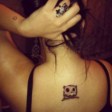 Cute Black Ink Small Owl Tattoo On Girl Upper Back