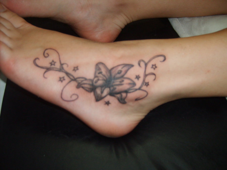 Cute Grey Lily Flower Tattoo On Left Foot
