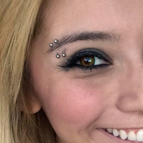 Dual Eyebrow Piercing With Silver Barbells