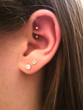 Dual Lobe And Rook Piercing On Girl Left Ear