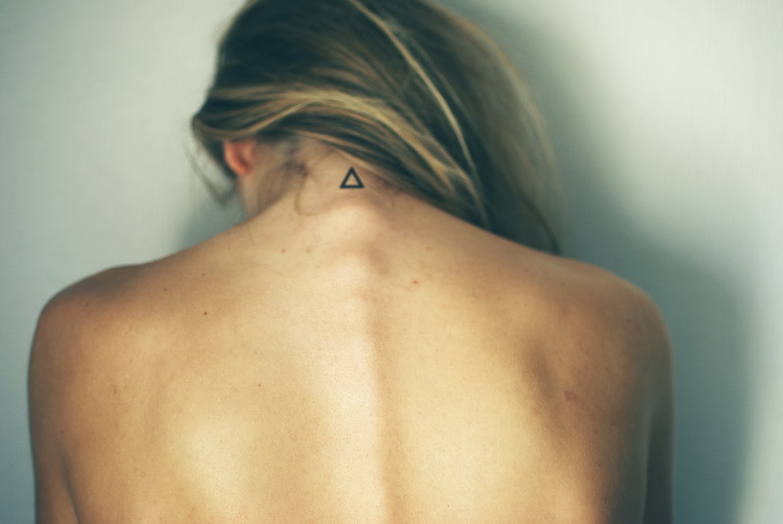 Fantastic Black Outline Triangle Tattoo On Girl Back Neck