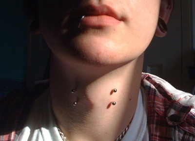 Front Neck Piercings With Silver Barbells