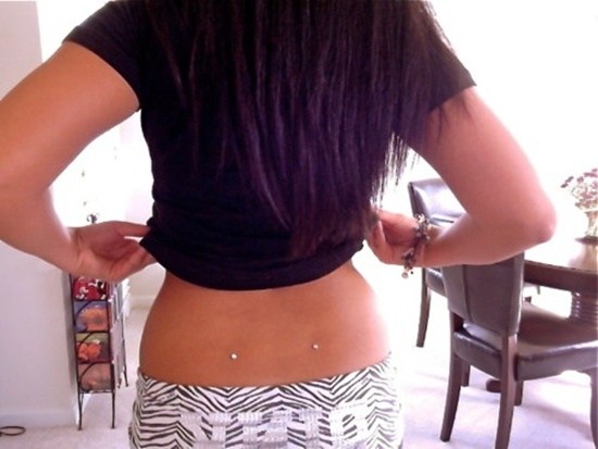 Girl Showing Her Back Dimple Piercing