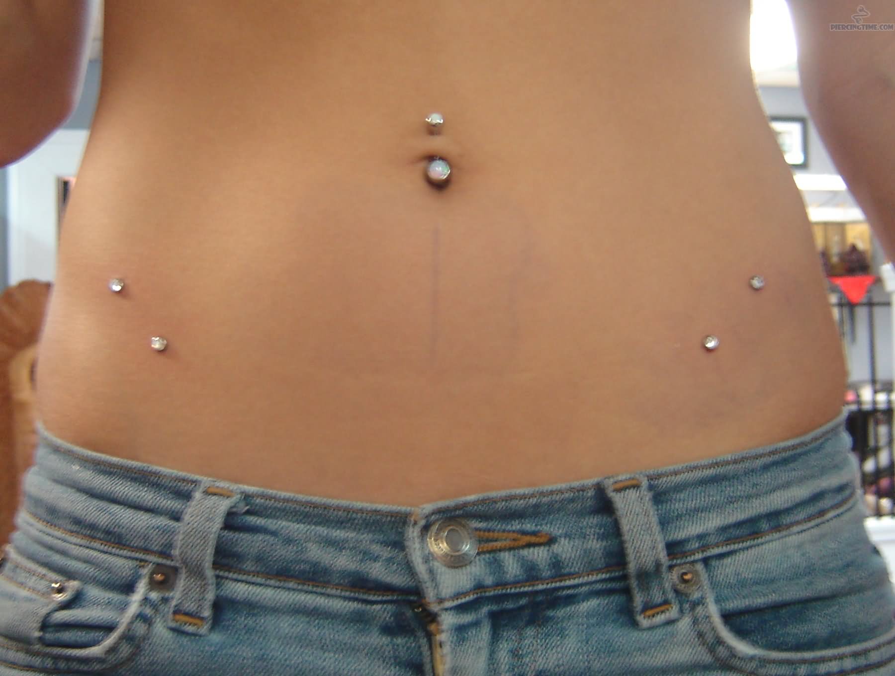 Girl With Belly Piercing And Hip Piercing With Dermal Anchors