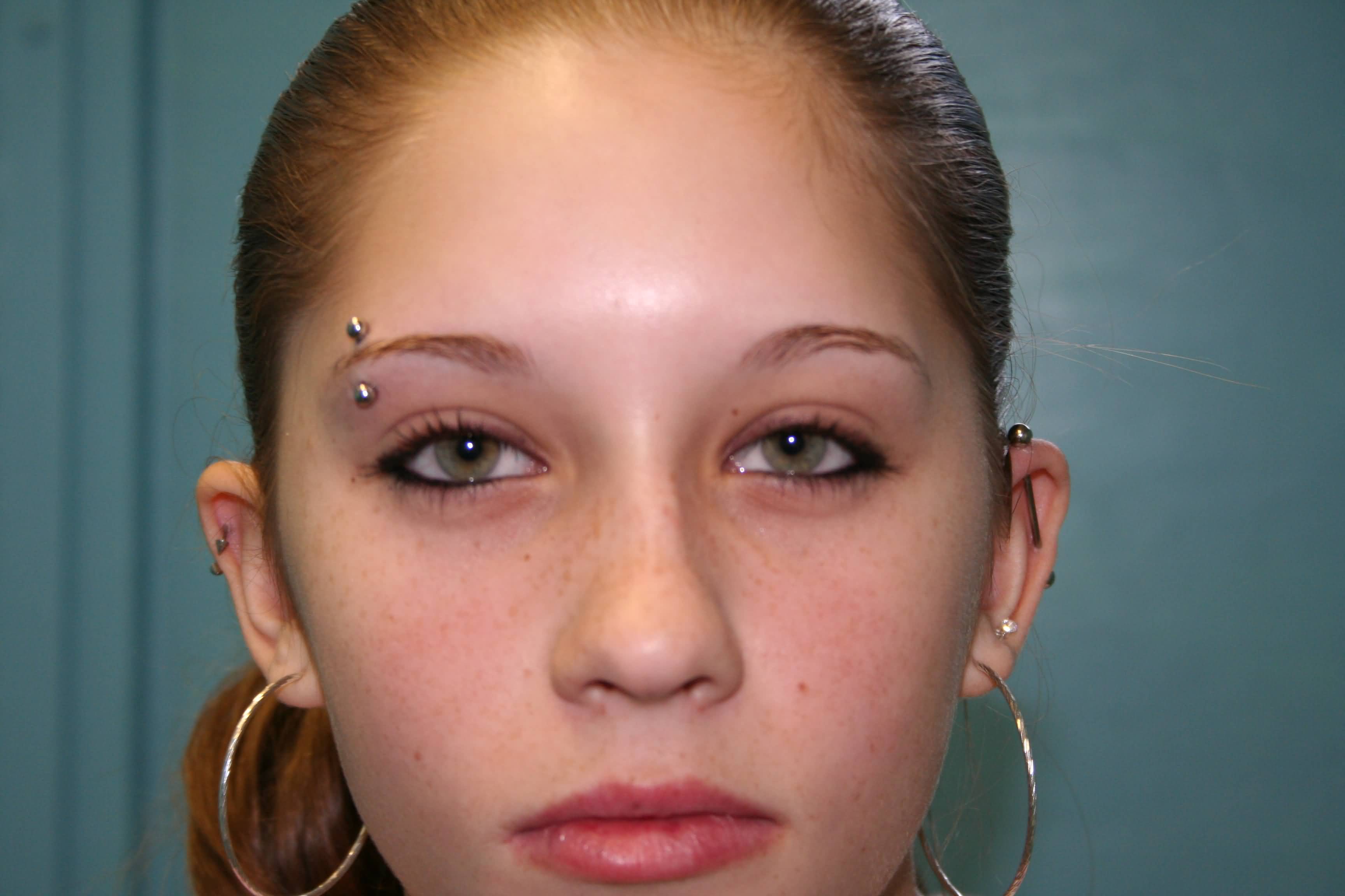 Girl With Right Eyebrow Piercing With Barbell