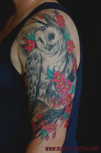 Grey Ink Owl With Red Flowers Tattoo On Man Left Half Sleeve