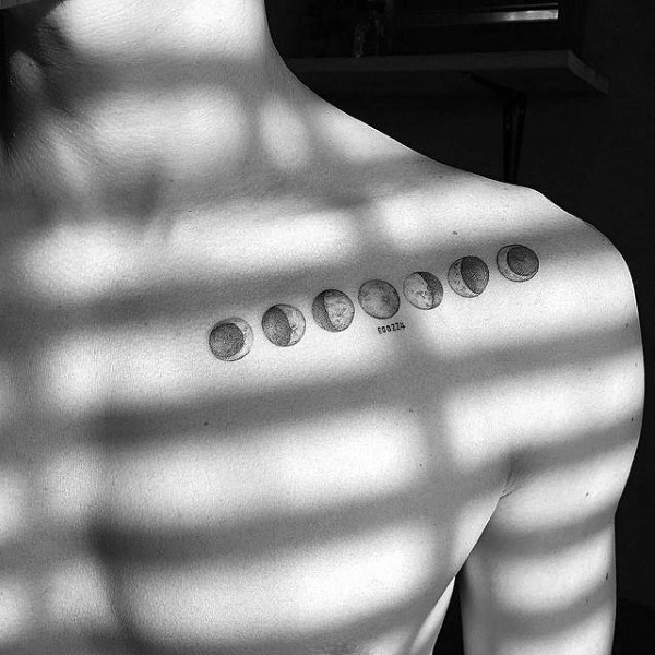 Grey Ink Phases Of The Moon Tattoo On Man Left Front Shoulder