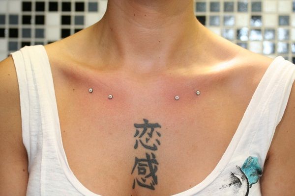 Kanji Tattoo And Clavicle Piercing With Dermals