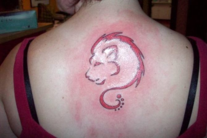 Latest Red Ink Leo Zodiac Sign Tattoo On Upper Back