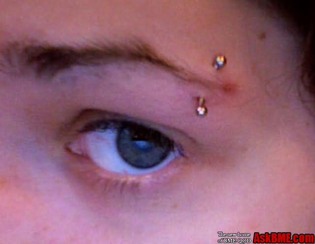 Left Eyebrow Piercing With Curved Barbell