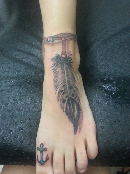 Left Toe Anchor Tattoo And Indian Feather Ankle Tattoo