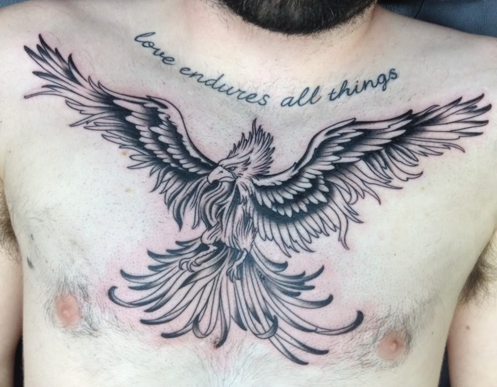 Love Endures All Things - Black Ink Flying Phoenix Tattoo On Man Chest