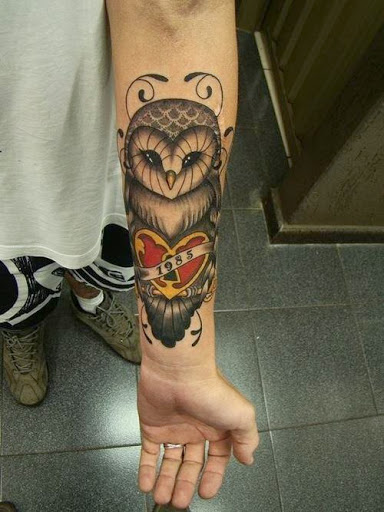 Memorial Owl With Heart Lock And Banner Tattoo On Left Forearm