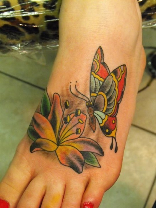 Nice Flower And Colored Butterfly Foot Tattoo