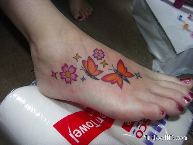Nice Pink Flowers And Butterfly Foot Tattoos