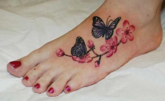 Pink Flowers And Butterfly Foot Tattoo For Girls