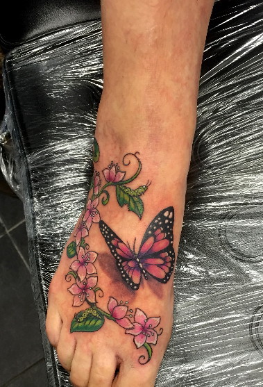 Pink Flowers And Butterfly Foot Tattoo