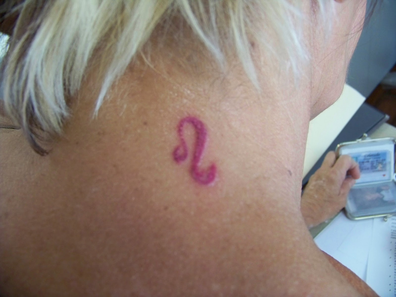 Pink Ink Leo Zodiac Sign Tattoo On Back Neck