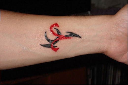 Red And Black Tribal Aries Zodiac Sign Tattoo On Left Wrist