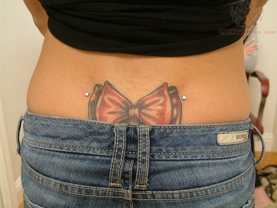 Red Bow Tattoo And Back Dimple Piercing Idea