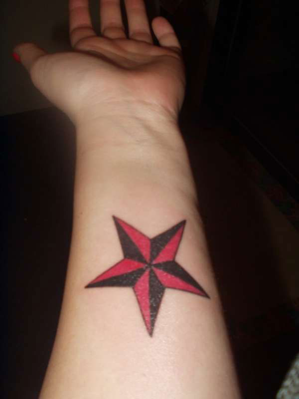 Red Nautical Star Tattoo on Left Wrist