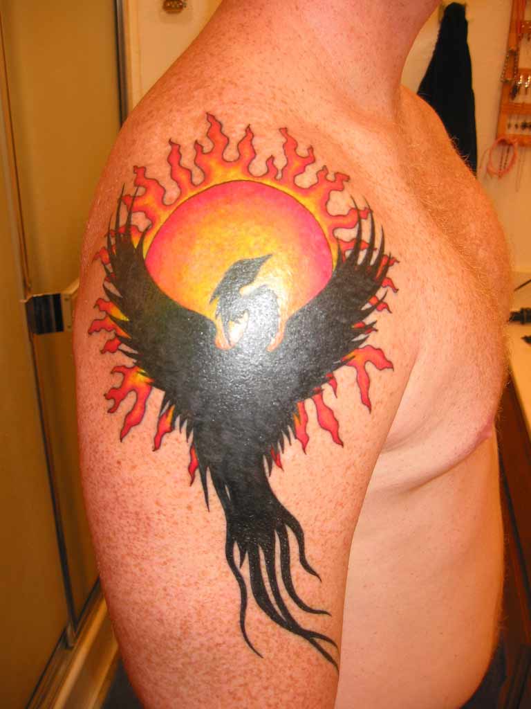 Silhouette Phoenix With Sun Tattoo On Man Right Upper Arm