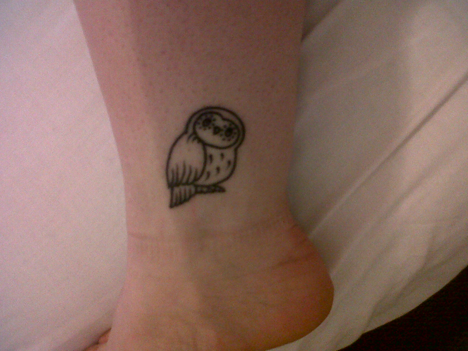 Simple Black Ink Small Owl Tattoo On Ankle