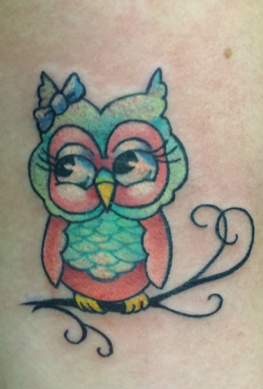 Simple Colorful Baby Owl On Branch Tattoo Design By Resonanteye