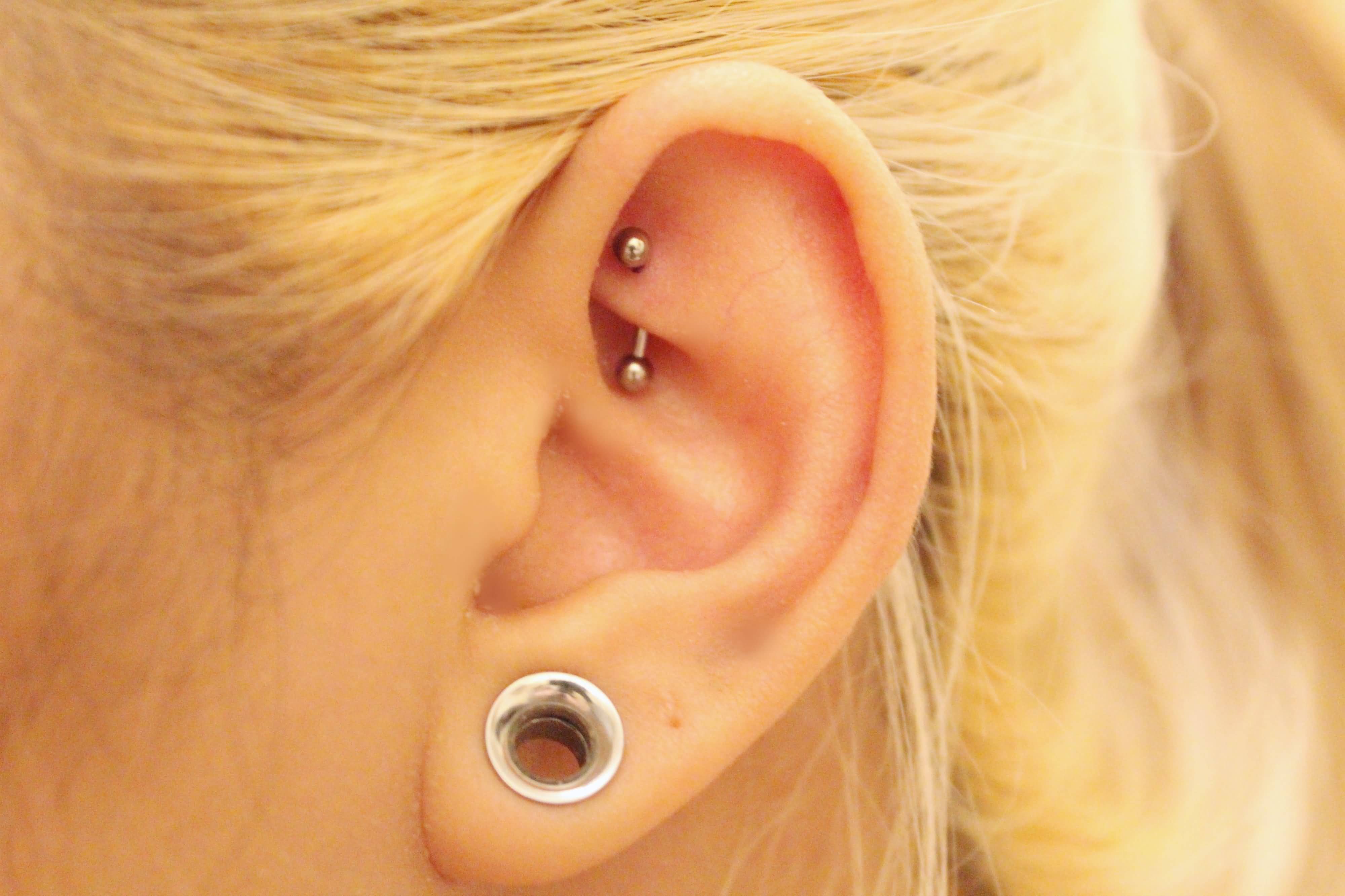 Stretched Lobe And Rook Piercing On Girl Left Ear