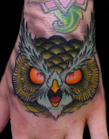 Traditional Owl Face Tattoo On Left Hand