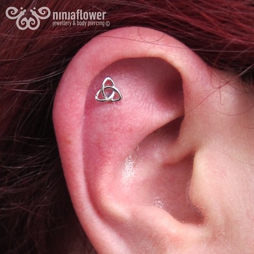 Triangle Helix Piercing On Girl Right Ear