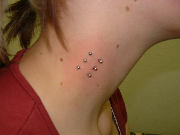 Tribal Surface Front Neck Piercings With Barbells