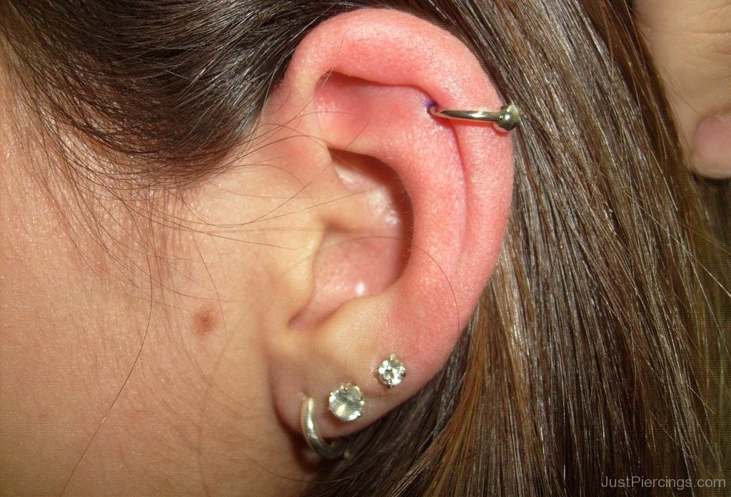 Triple Lobes and Helix Piercing On Girl Left Ear