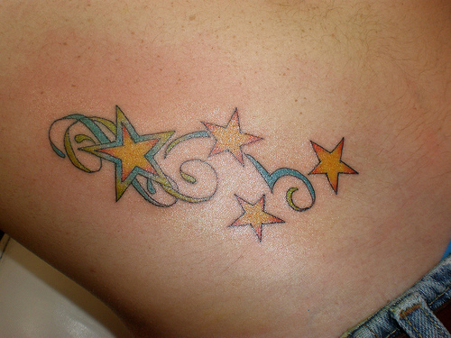 Yellow Star Tattoo On Hip