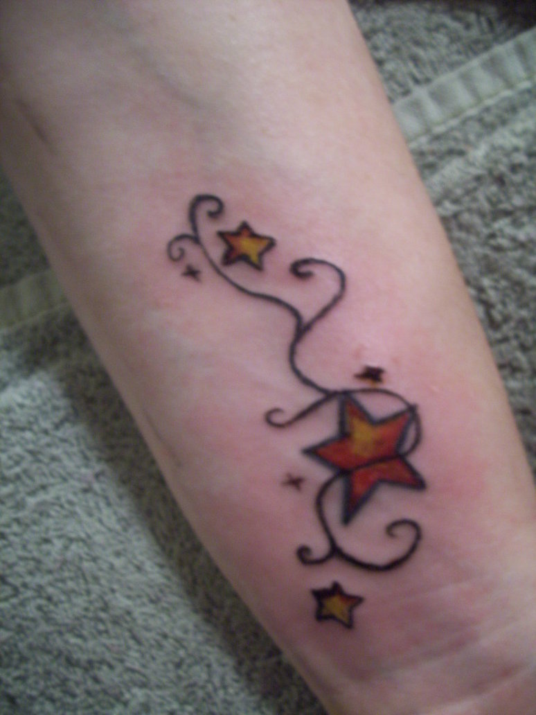 Yellow Star Tattoo On Left Wrist