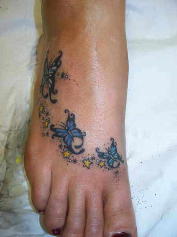 Yellow Stars And Butterflies Tattoo On Right Foot