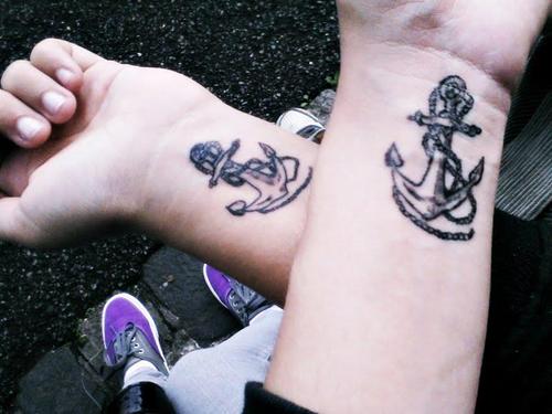 Attractive Black Ink Anchor Tattoo On Couple Wrist