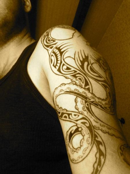 Attractive Black Ink Tribal Octopus Tattoo On Man Left Half Sleeve
