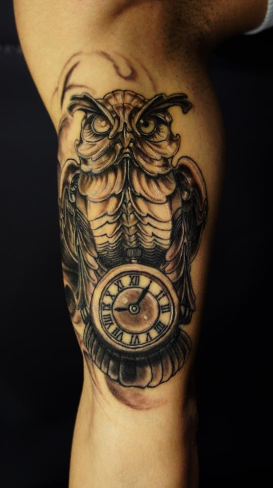 Awesome Black Ink Owl With Clock Tattoo On Right Bicep