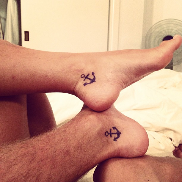 Black Anchor Tattoo On Couple Left Foot Ankle.