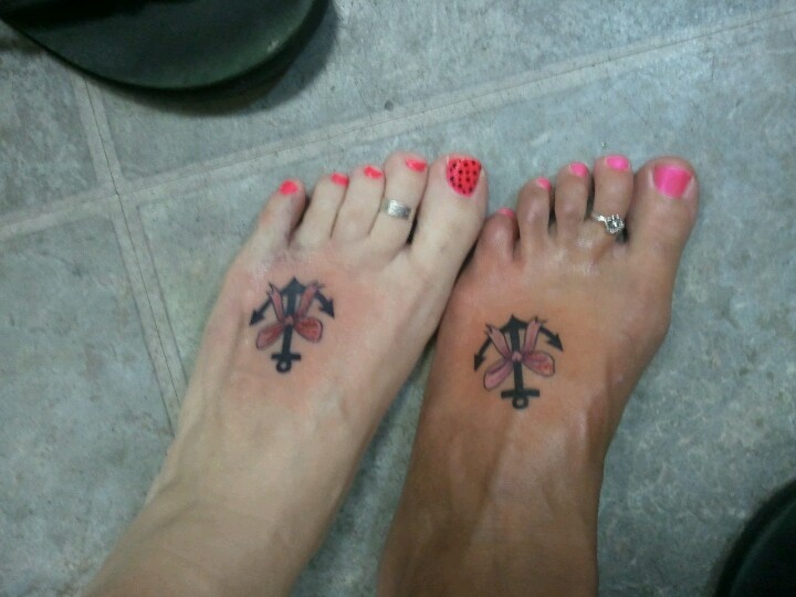 Black Anchor With Bow Tattoo On Couple Left Foot