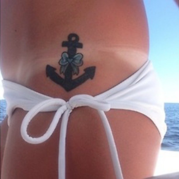 Black Anchor With Bow Tattoo On Girl Left Hip