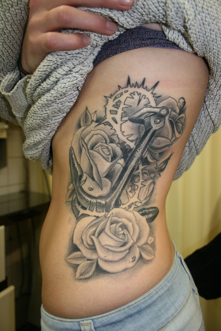Black And Grey 3D Anchor With Roses Tattoo On Girl Left Side Rib By Isnard Barbosa