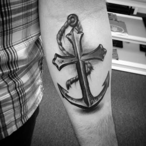 Black And Grey Cross Anchor Tattoo On Left Forearm