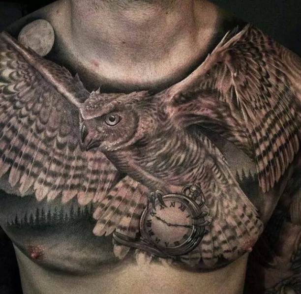 Black And Grey Flying Owl With Clock Tattoo On Man Chest